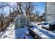 Snowy backyard with shed and patio furniture at 1621 Flemming Dr, Longmont, CO 80501