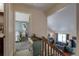 Upstairs hallway with a view of a bedroom and the living room below at 1621 Flemming Dr, Longmont, CO 80501