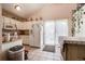 Kitchen with white cabinets and sliding door to patio at 1621 Flemming Dr, Longmont, CO 80501