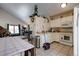 White kitchen cabinets, with view into living room at 1621 Flemming Dr, Longmont, CO 80501