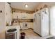 Efficient kitchen with white cabinets and appliances at 1621 Flemming Dr, Longmont, CO 80501