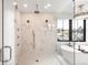 Luxurious bathroom with walk-in shower, soaking tub, and marble tile, creating a spa-like retreat at 754 S York St, Denver, CO 80209