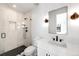 Modern bathroom features a glass enclosed shower and white vanity, accented with matte black fixtures at 754 S York St, Denver, CO 80209