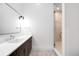 Modern bathroom with a sleek vanity, patterned floor, and a glass-enclosed shower at 754 S York St, Denver, CO 80209