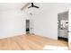 Modern, light-filled bedroom with hardwood floors, high ceilings, ceiling fan, and an ensuite bathroom at 754 S York St, Denver, CO 80209