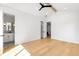 Modern bedroom with hardwood floors, an ensuite bathroom, a black ceiling fan, and ample natural light at 754 S York St, Denver, CO 80209