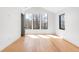 Bright, modern bedroom with hardwood floors, high ceilings, and large windows overlooking a treed landscape at 754 S York St, Denver, CO 80209