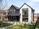 Striking two-story home with black and white exterior, large windows, and manicured lawn at 754 S York St, Denver, CO 80209