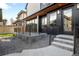 Modern home exterior with a concrete porch, gravel landscaping, and black trim at 754 S York St, Denver, CO 80209