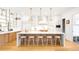 Well-lit kitchen with large island, pendant lighting, stainless appliances, and seating for five at 754 S York St, Denver, CO 80209