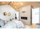 Inviting primary bedroom with wood ceiling, fireplace, and access to ensuite bath at 754 S York St, Denver, CO 80209