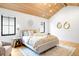 Bright and airy primary bedroom with wood ceiling, stylish decor, and natural light at 754 S York St, Denver, CO 80209