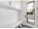 Well-lit mudroom featuring modern built-in storage, bench, and an exterior door with a window at 754 S York St, Denver, CO 80209