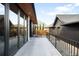 Back patio with concrete floor and iron railing that overlooks the back yard at 754 S York St, Denver, CO 80209