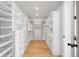 Bright walk-in closet with custom white shelving, drawers, and wood floors, perfect for organization and storage at 754 S York St, Denver, CO 80209