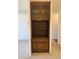 Built-in wooden cabinet is shown with glass doors and various storage compartments at 795 S Alton Way # 11C, Denver, CO 80247