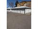 View of detached garages with white doors for resident parking, and building in the background at 795 S Alton Way # 11C, Denver, CO 80247