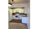 Compact kitchen with white appliances, ample cabinet space, and a modern countertop at 795 S Alton Way # 11C, Denver, CO 80247