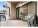 Outdoor balcony with sliding glass doors and a grill at 250 Columbine St # 210, Denver, CO 80206