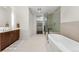 Modern bathroom with a soaking tub, glass shower, and a double vanity at 250 Columbine St # 210, Denver, CO 80206