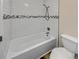 Bathroom with a white tiled shower and white toilet at 389 S Kalispell Way # C, Aurora, CO 80017