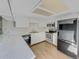 Well-lit kitchen with white cabinets, stainless steel appliances, and ample counter space at 389 S Kalispell Way # C, Aurora, CO 80017
