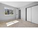 Cozy bedroom with a large window, closet, and neutral carpet at 13254 E Asbury Dr, Aurora, CO 80014