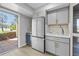 Bright eat-in kitchen featuring gray cabinets, stainless appliances, wine fridge, and an exterior view at 13254 E Asbury Dr, Aurora, CO 80014