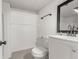 Basement bathroom featuring white tile, toilet, and mirror at 1636 Geneva St, Aurora, CO 80010