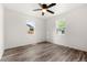 Bright bedroom with a ceiling fan, wood floors, and two windows at 1636 Geneva St, Aurora, CO 80010