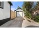 Detached one car garage with a concrete driveway and partial fence at 1636 Geneva St, Aurora, CO 80010