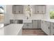 Contemporary kitchen featuring gray cabinetry, modern fixtures, stainless appliances, and bright countertops at 1636 Geneva St, Aurora, CO 80010