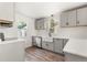 Well-lit kitchen featuring gray cabinets, a farmhouse sink, stainless steel appliances, and light countertops at 1636 Geneva St, Aurora, CO 80010