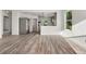 Bright open-concept living area with new laminate flooring flowing into a modern kitchen space at 1636 Geneva St, Aurora, CO 80010