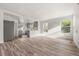 Bright and spacious living room featuring hardwood floors and large windows overlooking the front yard at 1636 Geneva St, Aurora, CO 80010