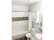 Clean bathroom with tile accents features a shower-tub, granite countertop sink, and built-in storage at 17090 E Ford Dr # 209, Aurora, CO 80017