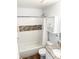 Clean bathroom with tile accents features a shower-tub, granite countertop sink, and built-in storage at 17090 E Ford Dr # 209, Aurora, CO 80017