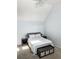 Bright bedroom featuring a queen-size bed, vaulted ceiling, ceiling fan, and neutral decor at 17090 E Ford Dr # 209, Aurora, CO 80017