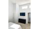Stylish bedroom with a modern dresser, and flat screen TV includes doorway to additional living space at 17090 E Ford Dr # 209, Aurora, CO 80017