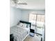 Comfortable bedroom featuring a ceiling fan, cozy bed, and sliding glass door to a private balcony at 17090 E Ford Dr # 209, Aurora, CO 80017