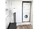 Functional laundry area with a stacked washer and dryer unit at 17090 E Ford Dr # 209, Aurora, CO 80017