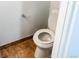 A cozy half-bathroom with a toilet and tiled floor at 17090 E Ford Dr # 209, Aurora, CO 80017