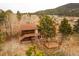 Cabin style home with upper deck and lower level entrance and detached patio with scenic wooded views at 26167 De Berry St, Conifer, CO 80433