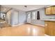 Bright kitchen area with white door and window, wood floors, built in shelving, and neutral grey paint at 26167 De Berry St, Conifer, CO 80433