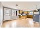 A spacious kitchen features wood cabinets, a breakfast bar, and plenty of natural light from a window at 26167 De Berry St, Conifer, CO 80433