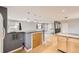 Open kitchen area with wood floors, a grey serving counter, and bar stool seating at 26167 De Berry St, Conifer, CO 80433