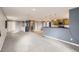 Open concept living room and kitchen featuring neutral gray walls at 26167 De Berry St, Conifer, CO 80433