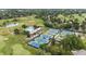 Aerial view of the tennis courts, pool, and a section of the community golf course at 4 Doral Ln, Littleton, CO 80123