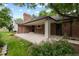 Brick home featuring a covered patio and a well-manicured backyard at 4 Doral Ln, Littleton, CO 80123