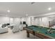 Finished basement with a pool table, L-shaped couch and TV perfect for entertainment at 4 Doral Ln, Littleton, CO 80123